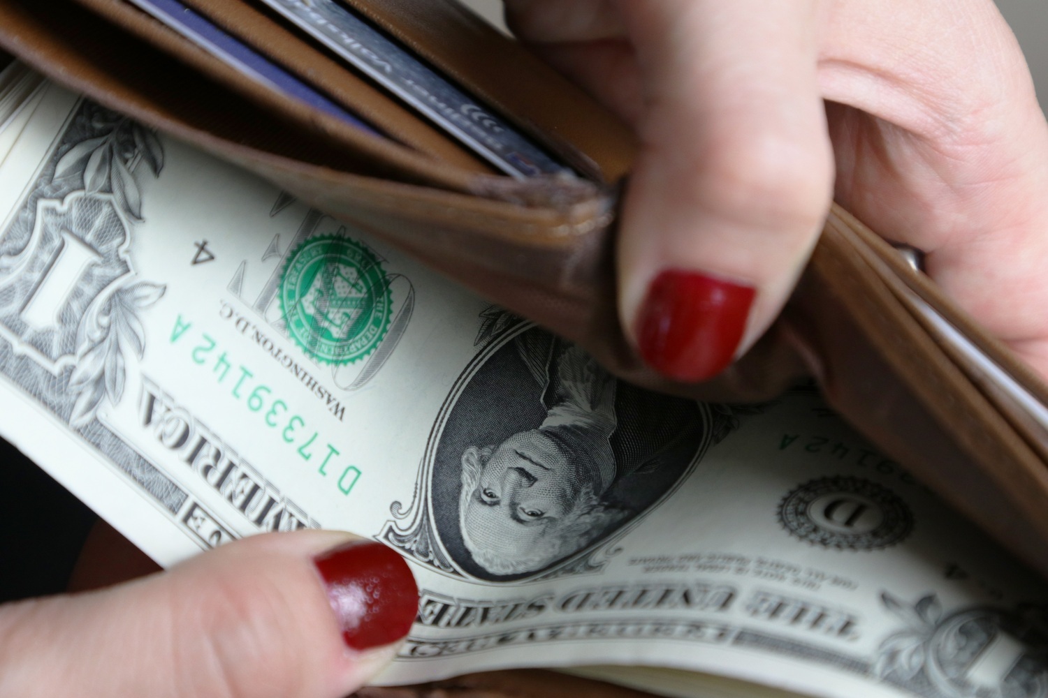 Close-up of leather wallet with cash, representing rising costs and household budget pressure